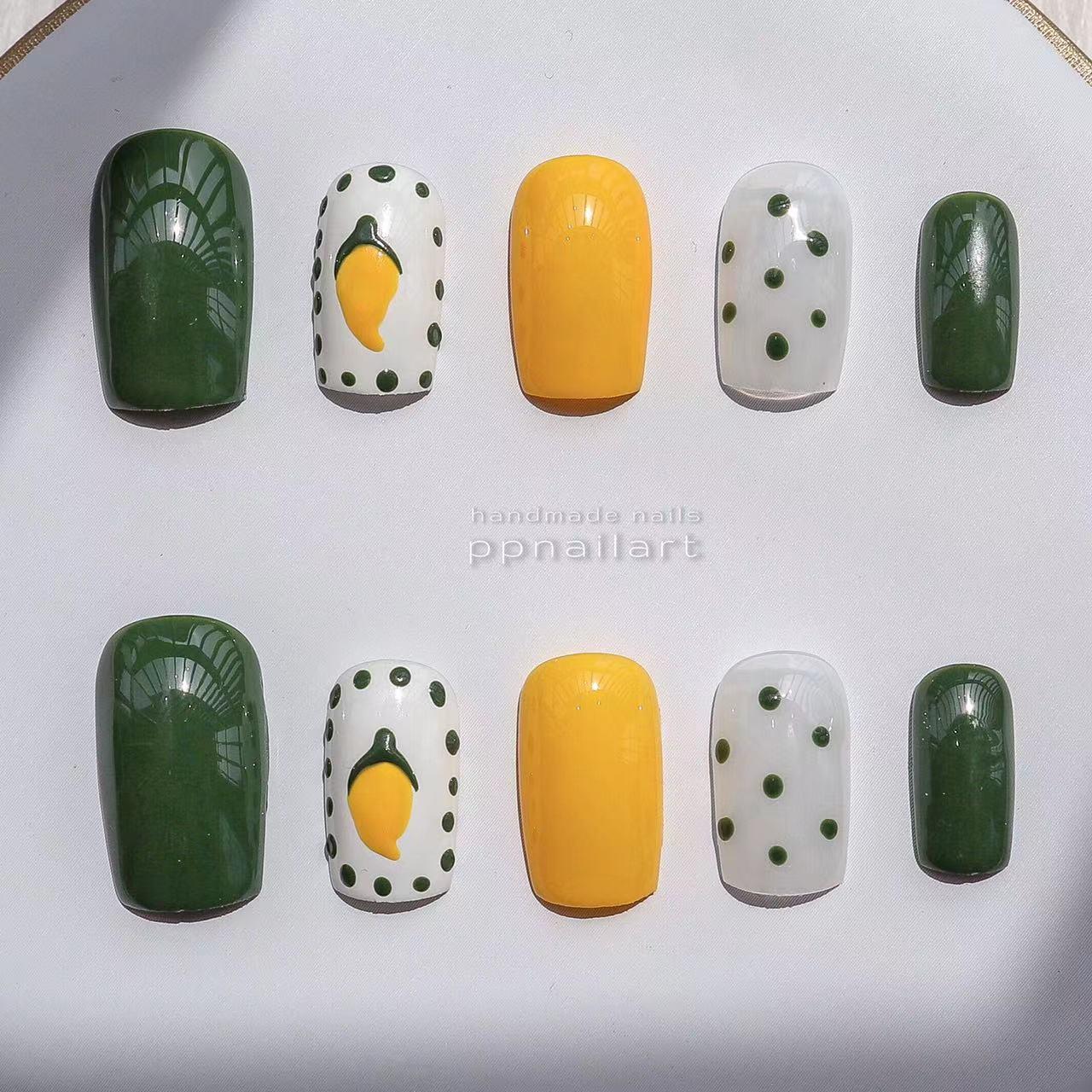 Designer: XinXin 10. Mango yellow green handmade nails